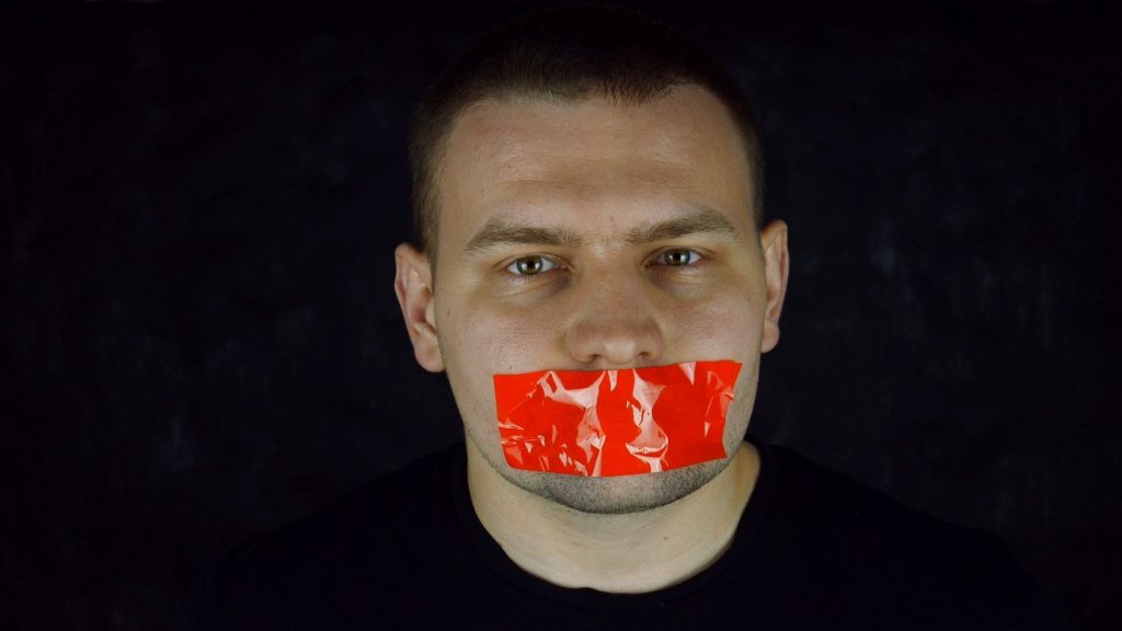 Guy with tape over his mouth - silenced